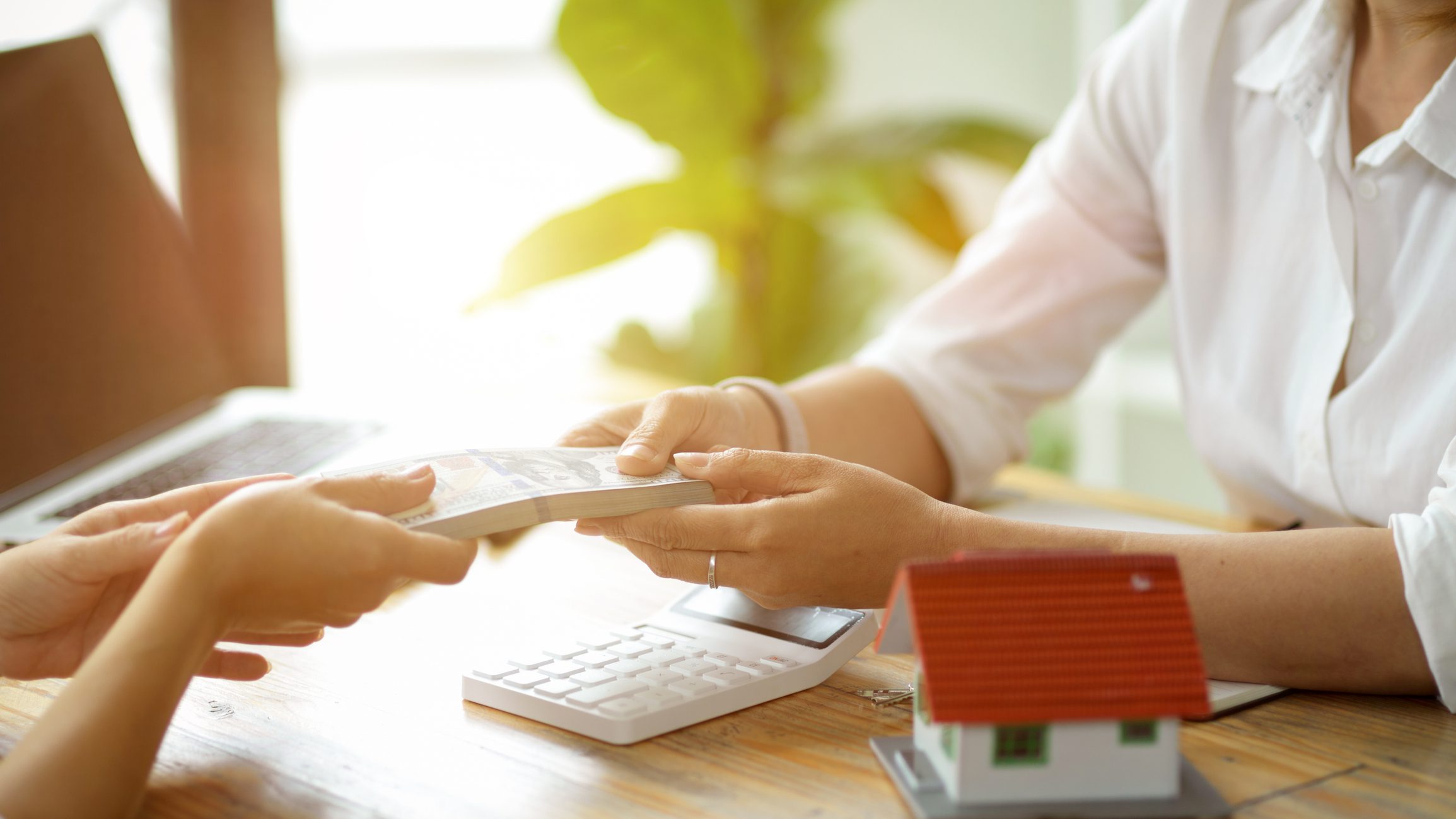 Hands passing paperwork in office